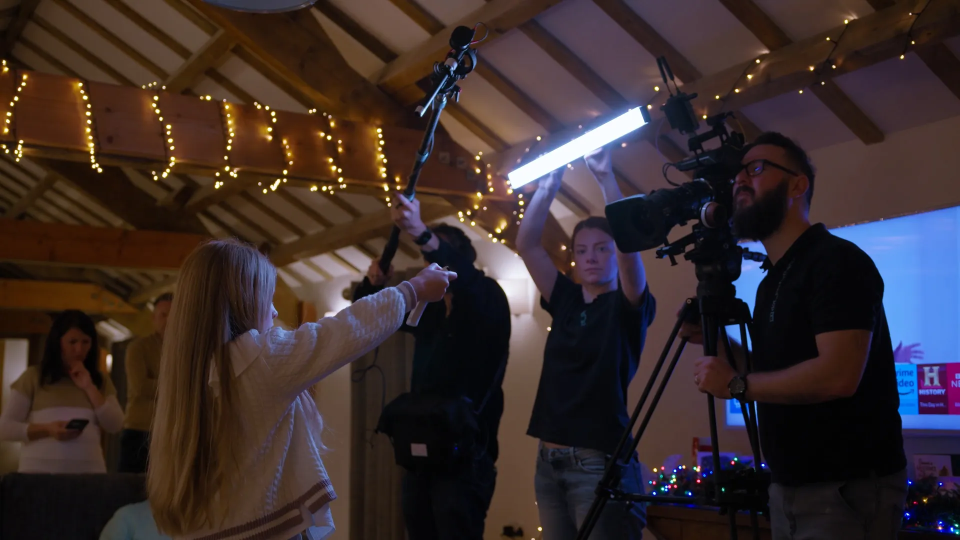 Dave Armstrong, Ella Garvey, Nico van Loggerenberg and Vivi filming inside a decorated venue on the Isle of Man, during a brand film production